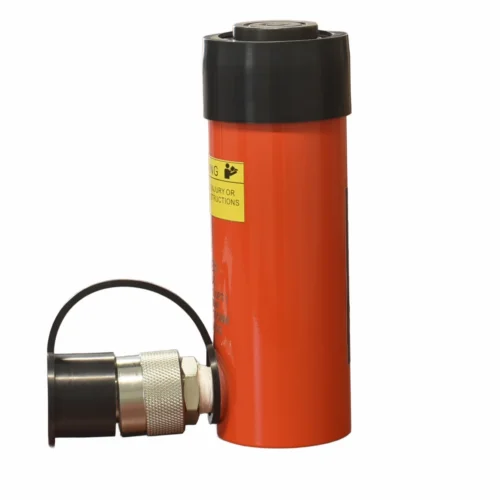 Orange hydraulic bottle jack standing upright with a black top cap and a separate metal release attachment lying to the side