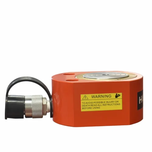 Orange industrial safety device with a warning label and a knurled metal coupling on a black protective sleeve attached to a shaft.