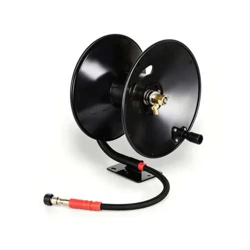 30m pressure washer hose reel steel | black metal hose reel on a base with a coiled hose and brass fittings, resting on a white surface.